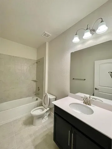 a bathroom with a double vanity sink toilet and shower