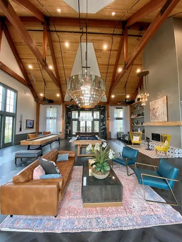 a living room with patio furniture and a chandelier