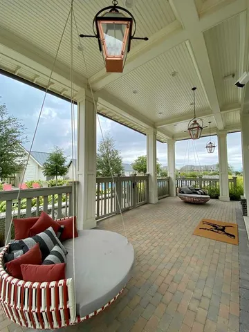 a view of a porch with furniture and a floor to ceiling window
