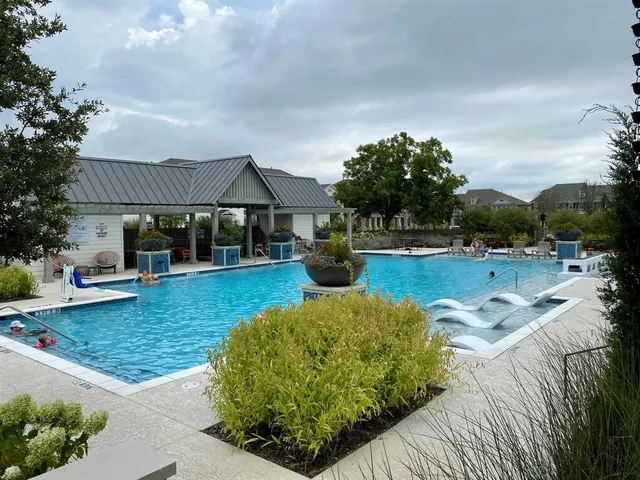 a view of a house with swimming pool and sitting area