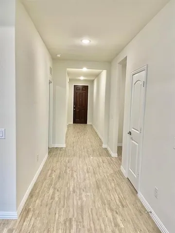 a view of hallway with wooden floor