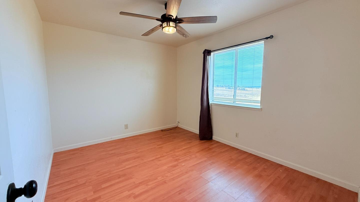 7947 Camp Far West Road Wheatland, CA 95692 - Photo 13 of 32 an empty room with a window and ceiling fan