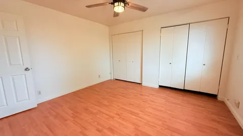 a view of an empty room with a ceiling fan