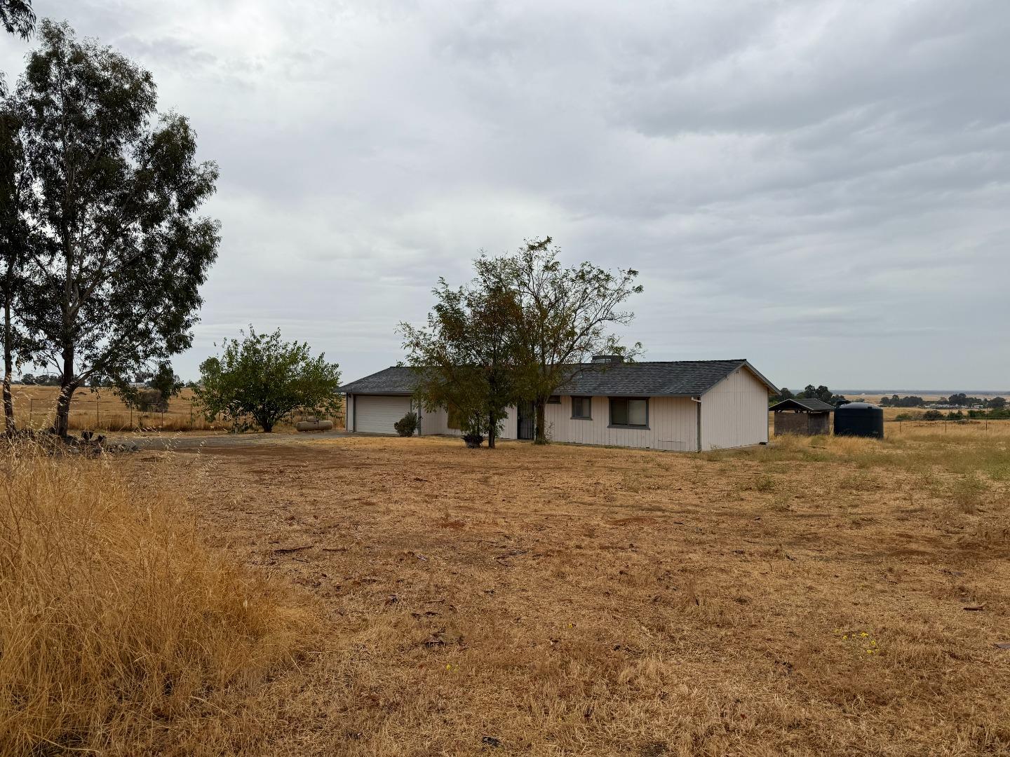 7947 Camp Far West Road Wheatland, CA 95692 - Photo 10 of 32 a front view of a house with a yard and trees