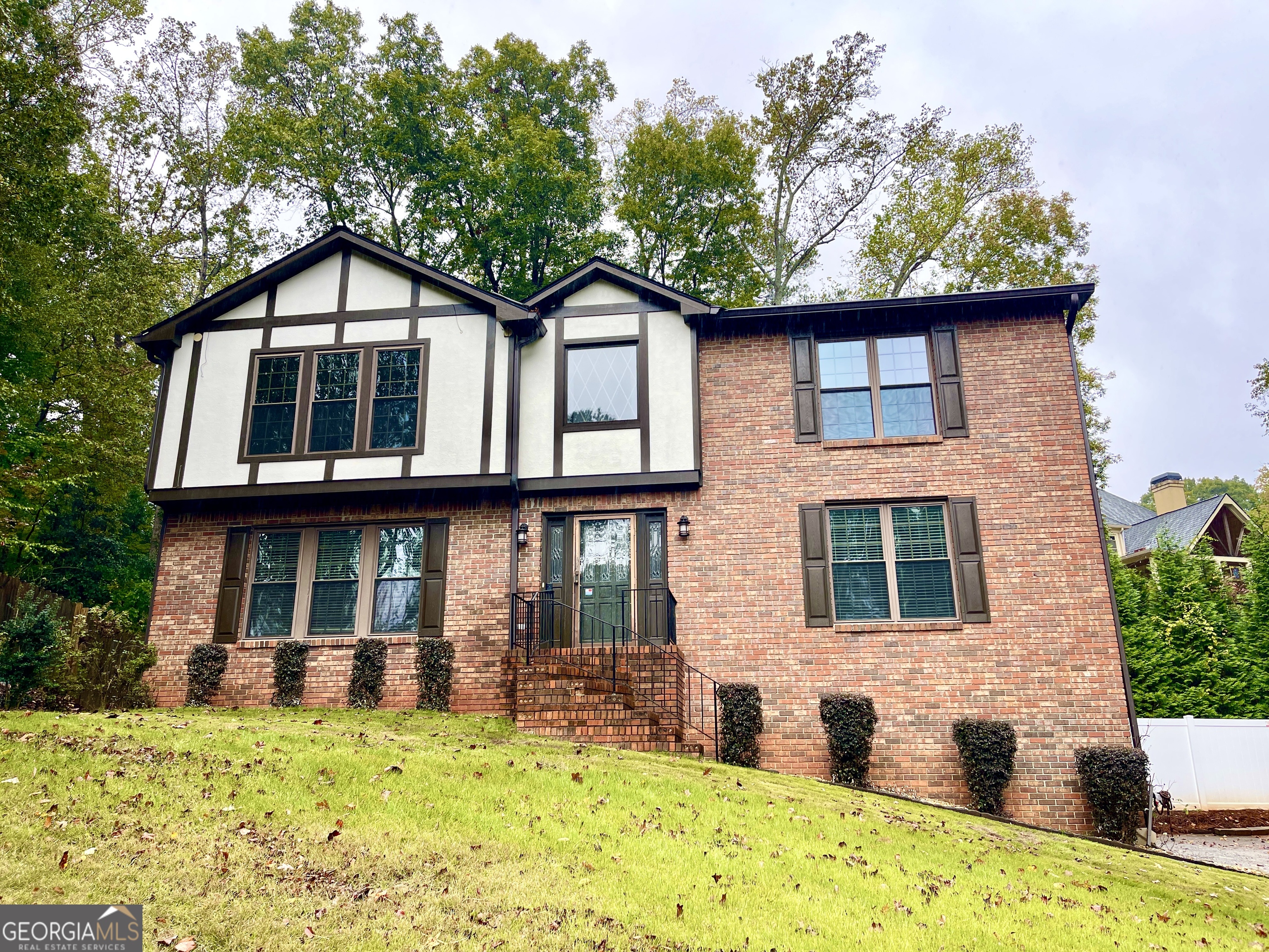 a front view of a house with a garden