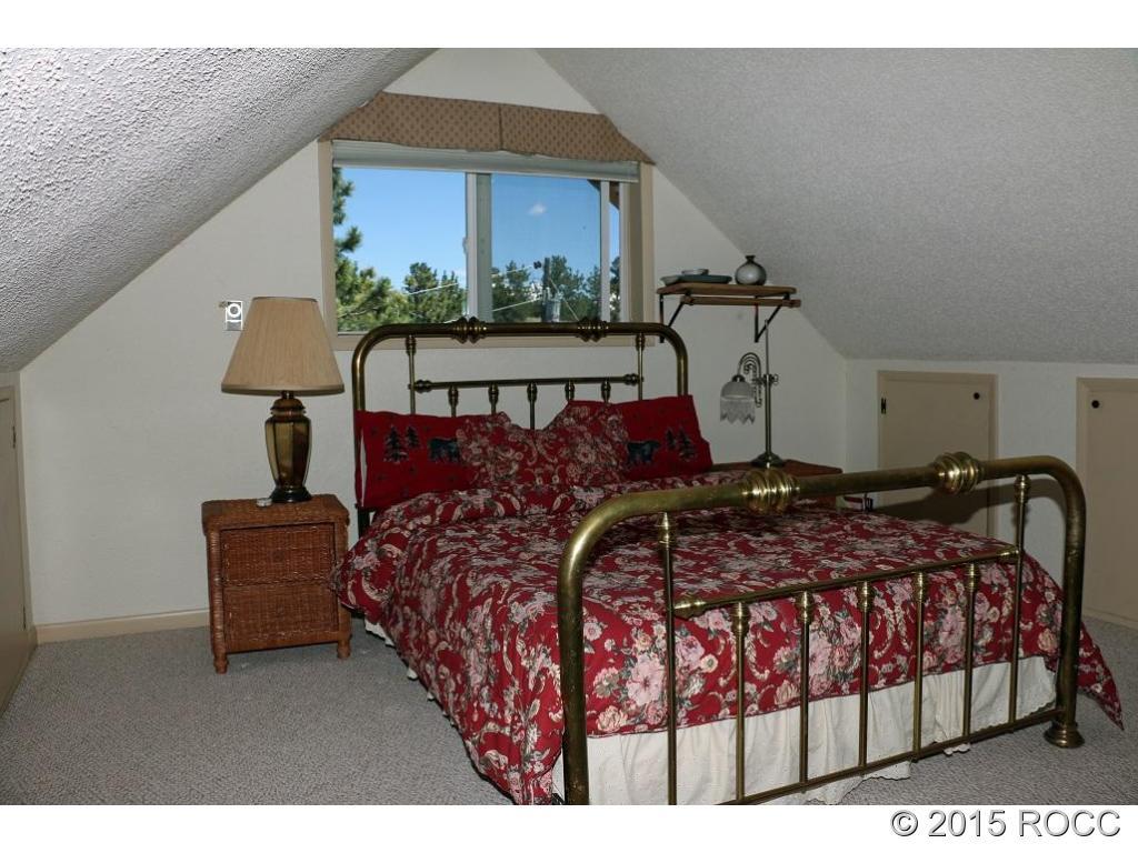 159 Kankakee Road Westcliffe, CO 81252 - Photo 11 of 22 a bedroom with a bed and window