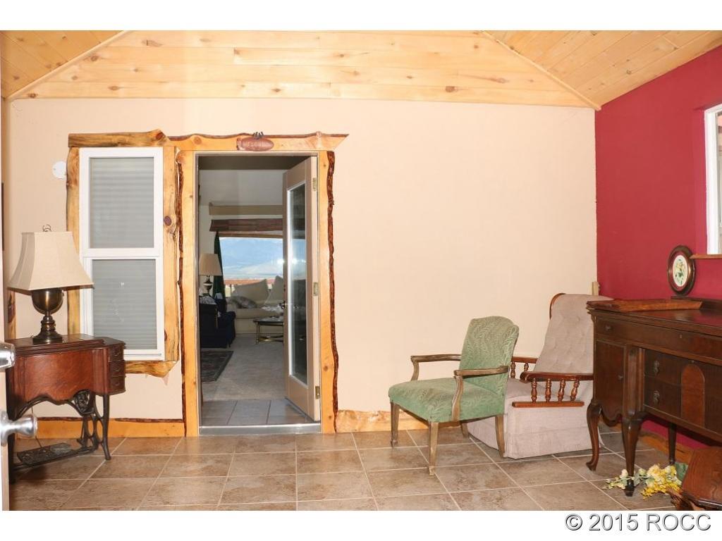 159 Kankakee Road Westcliffe, CO 81252 - Photo 15 of 22 a view of balcony with two chairs and a table