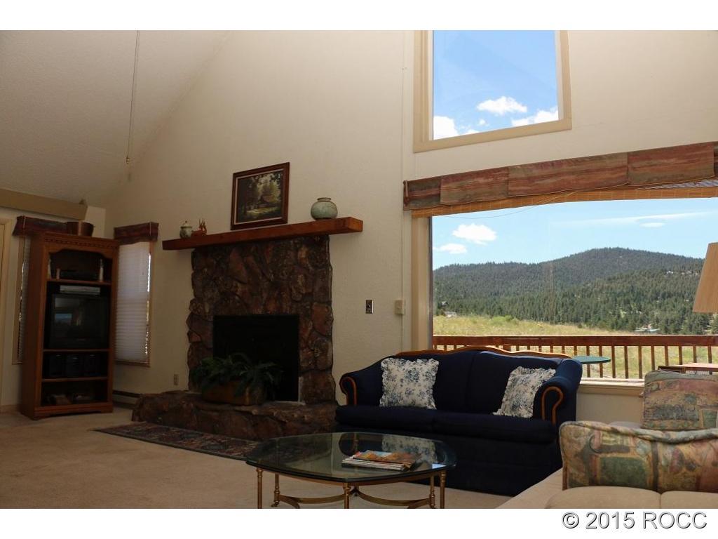 159 Kankakee Road Westcliffe, CO 81252 - Photo 21 of 22 a living room with furniture and a fireplace