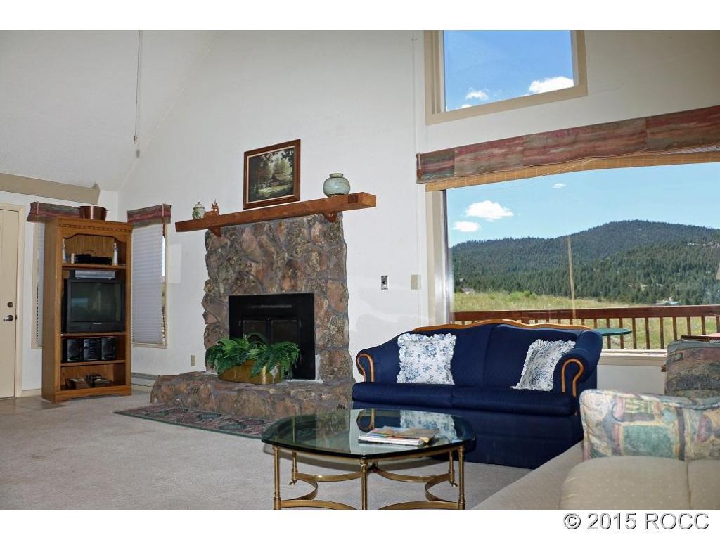 159 Kankakee Road Westcliffe, CO 81252 - Photo 3 of 22 a living room with furniture and a fireplace