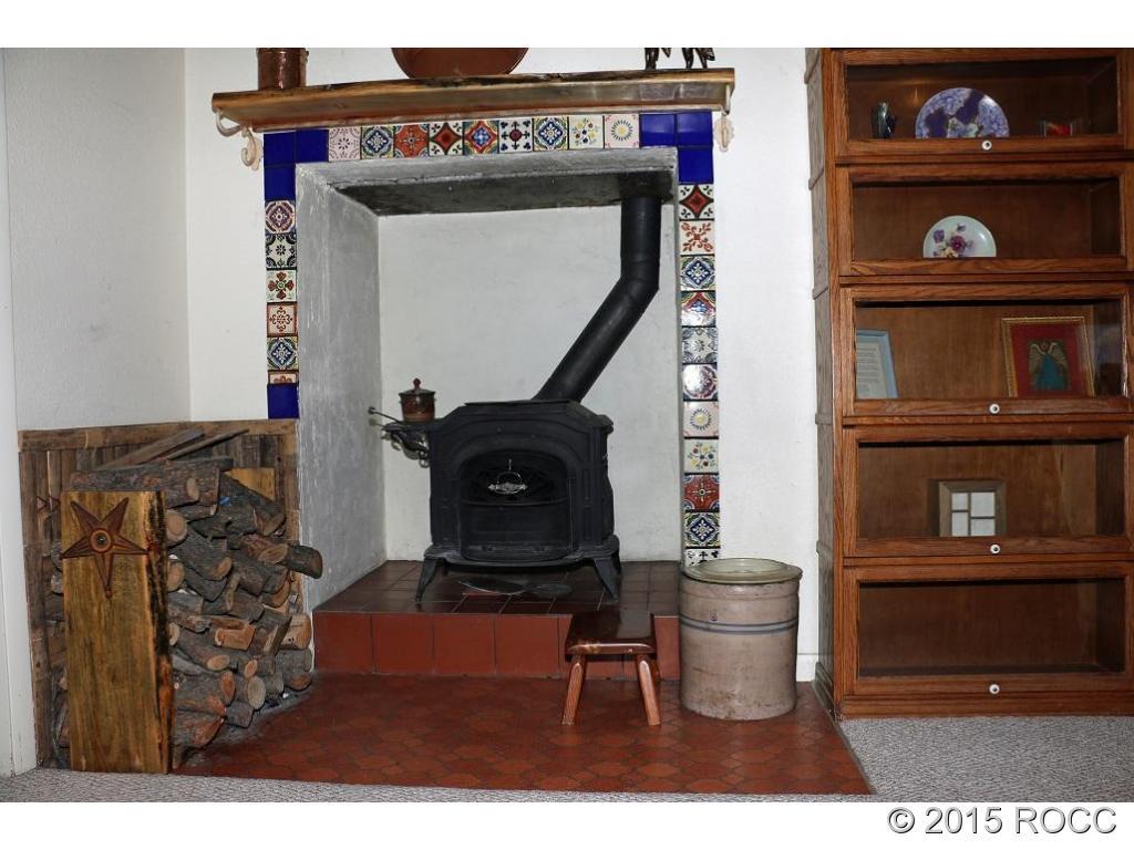 159 Kankakee Road Westcliffe, CO 81252 - Photo 7 of 22 a living room with furniture a rug and a fireplace
