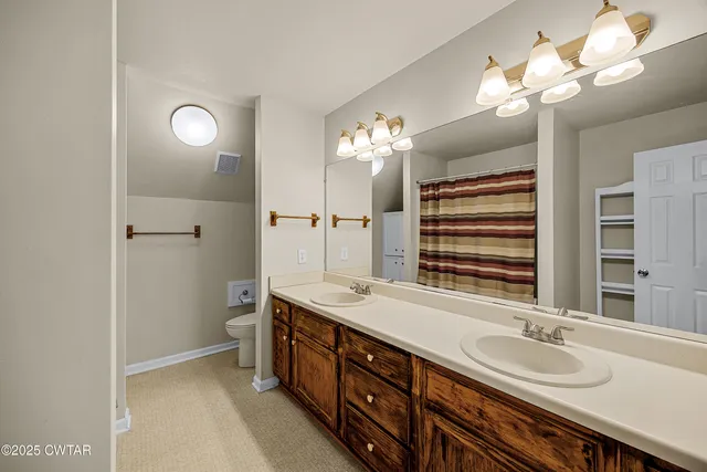 a bathroom with a double vanity sink and a mirror