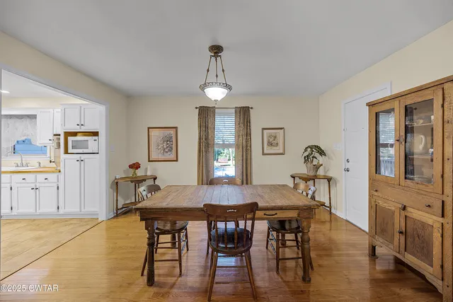 a view of a dining room with furniture and window