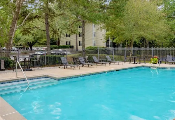 a view of a swimming pool with a table and chairs