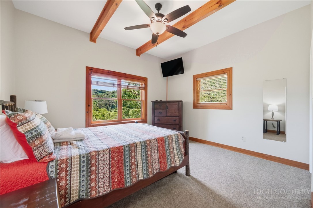 850 River Ridge Road Boone, NC 28607 - Photo 12 of 26 a bed sitting in a bedroom next to a window