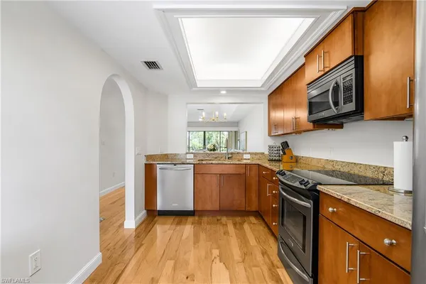 a kitchen with stainless steel appliances granite countertop a stove and a sink