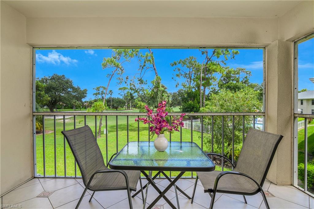 701 Augusta Boulevard, Unit 7018 Naples, FL 34113 - Photo 22 of 30 a view of a chairs and table in patio