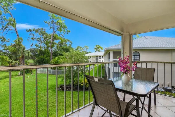 a balcony with table and chairs