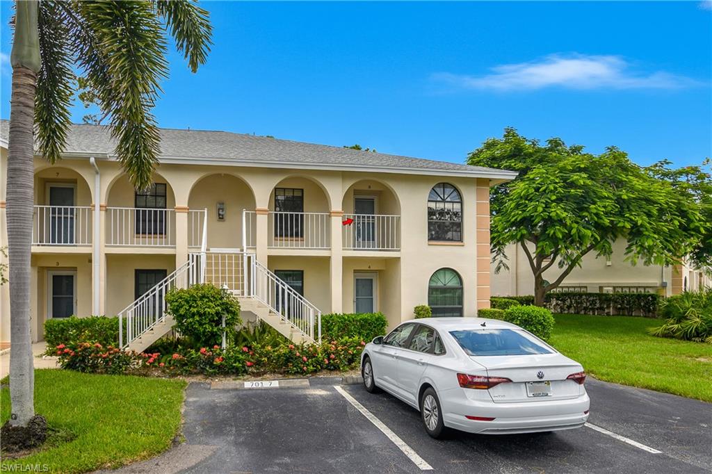 701 Augusta Boulevard, Unit 7018 Naples, FL 34113 - Photo 27 of 30 a front view of a house with a yard