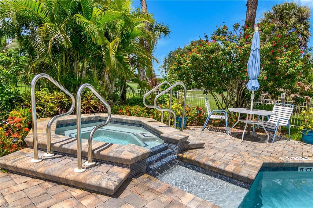 701 Augusta Boulevard, Unit 7018 Naples, FL 34113 - Photo 30 of 30 a view of a swimming pool with lawn chairs potted plants