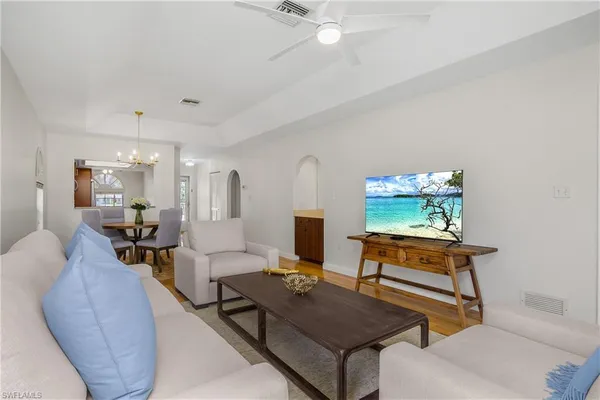 a living room with furniture and a wooden floor