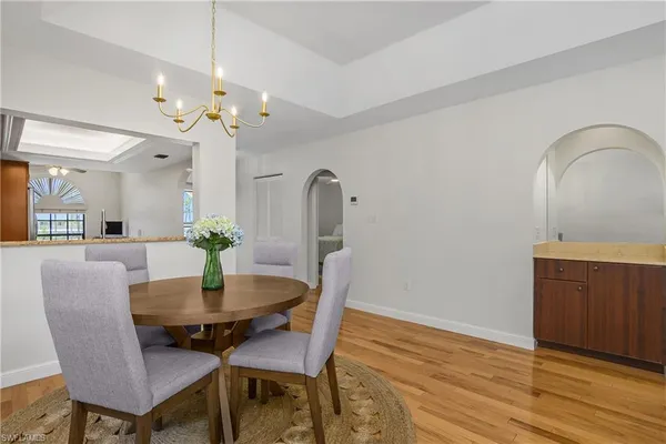 a view of a dining room with furniture and wooden floor