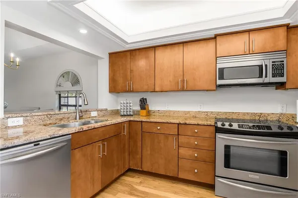 a kitchen with a sink stove and cabinets