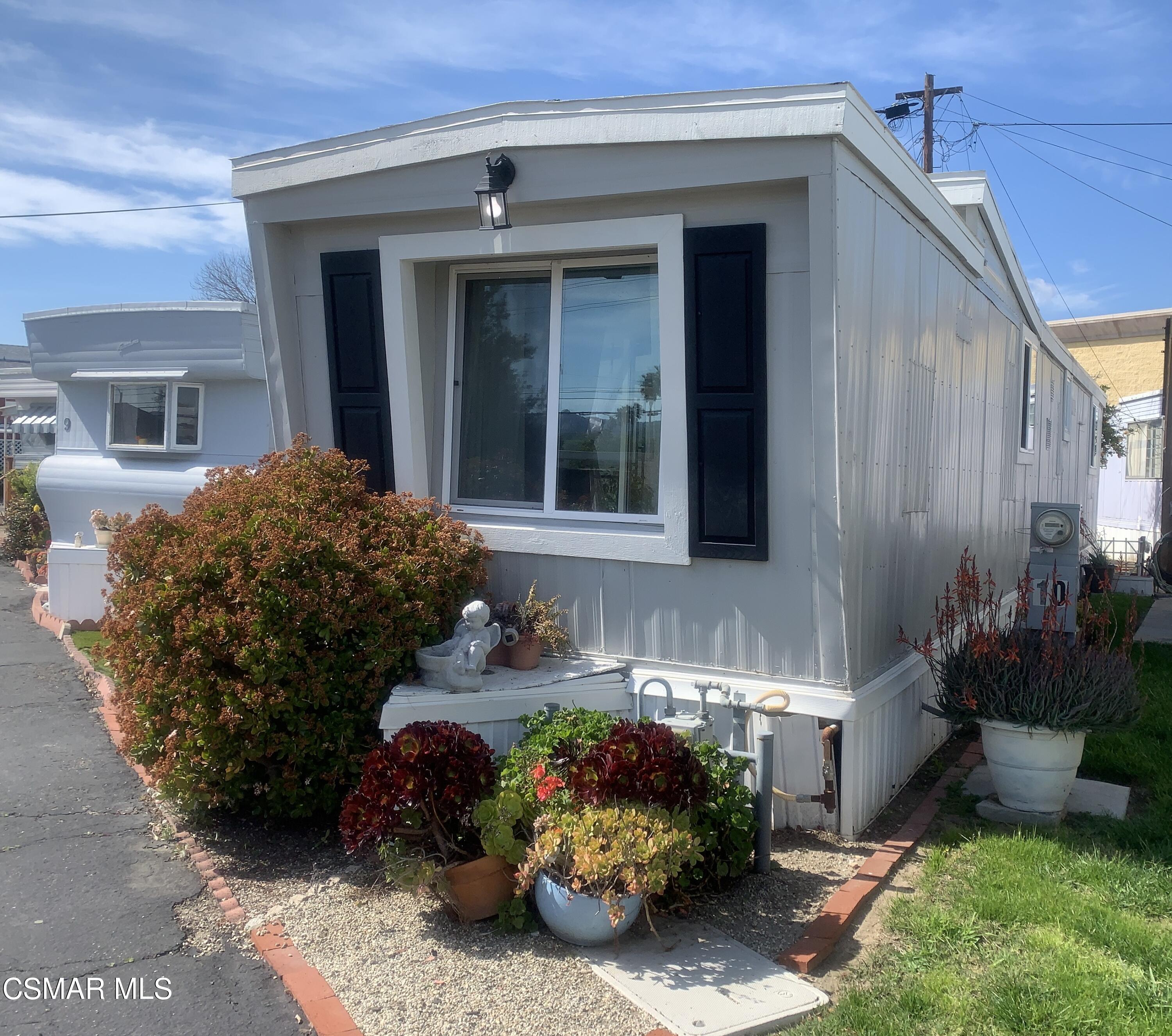 4381 Cochran Street, Unit 10 Simi Valley, CA 93063 - Photo 1 of 32 a front view of a house with a garden