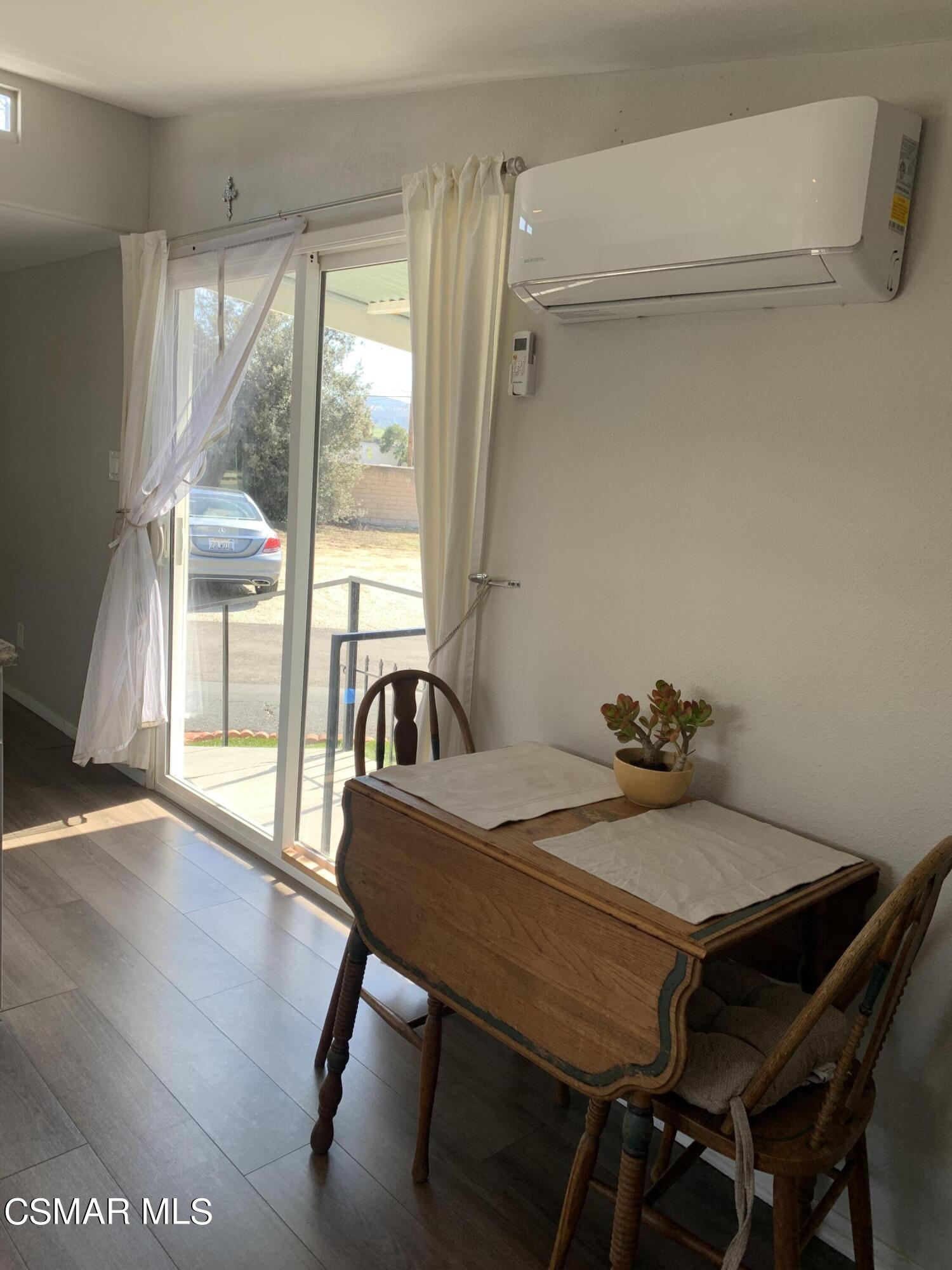 4381 Cochran Street, Unit 10 Simi Valley, CA 93063 - Photo 13 of 32 a view of a dining room with furniture window and wooden floor