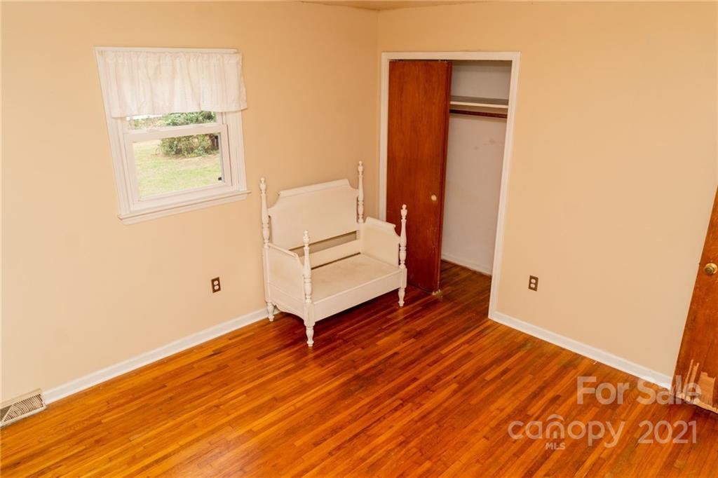 4150 McCoy Street Midland, NC 28107 - Photo 19 of 26 a view of an empty room with wooden floor and a window