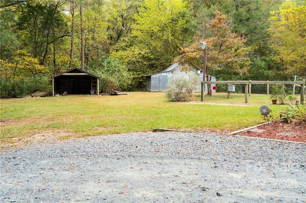 4150 McCoy Street Midland, NC 28107 - Photo 23 of 26 a front view of a house with a garden and trees