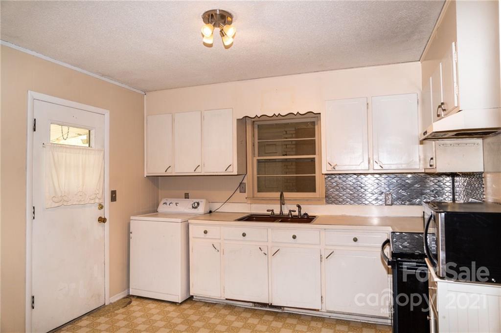 4150 McCoy Street Midland, NC 28107 - Photo 10 of 26 a kitchen with a sink stove and cabinets