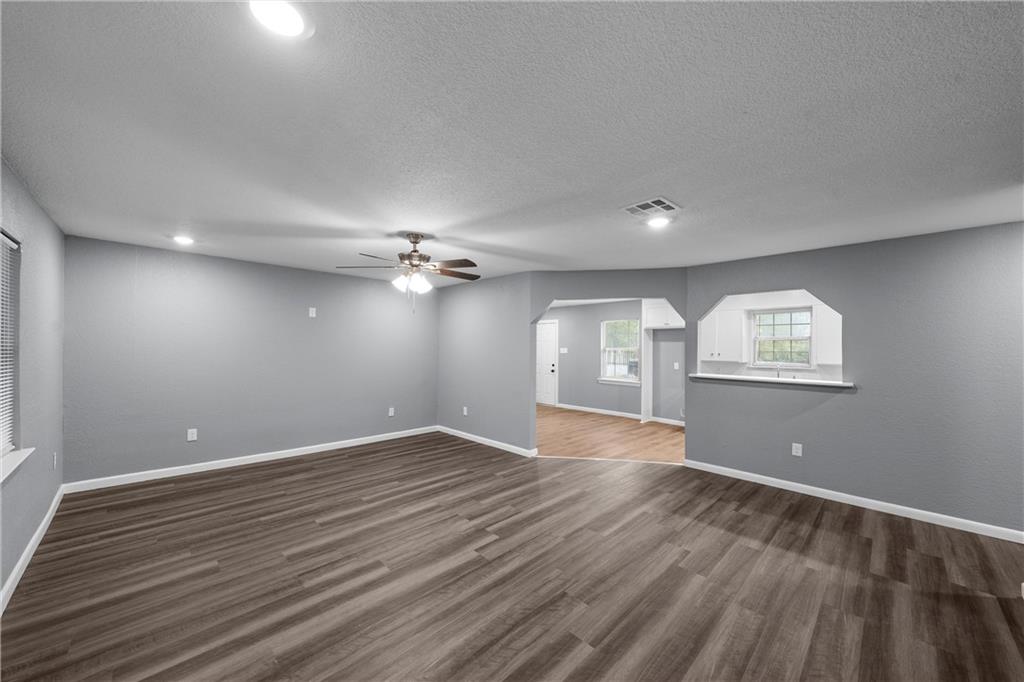 12932 Old Dallas Road West, TX 76691 - Photo 2 of 16 wooden floor in an empty room with a window