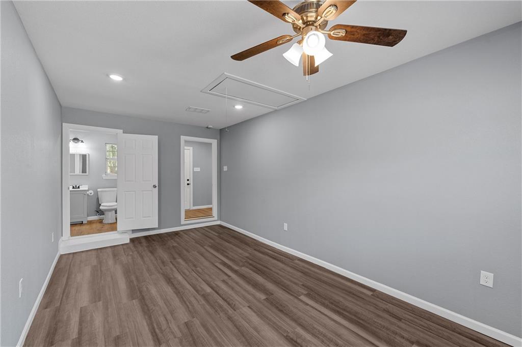 12932 Old Dallas Road West, TX 76691 - Photo 7 of 16 wooden floor in an empty room with a window