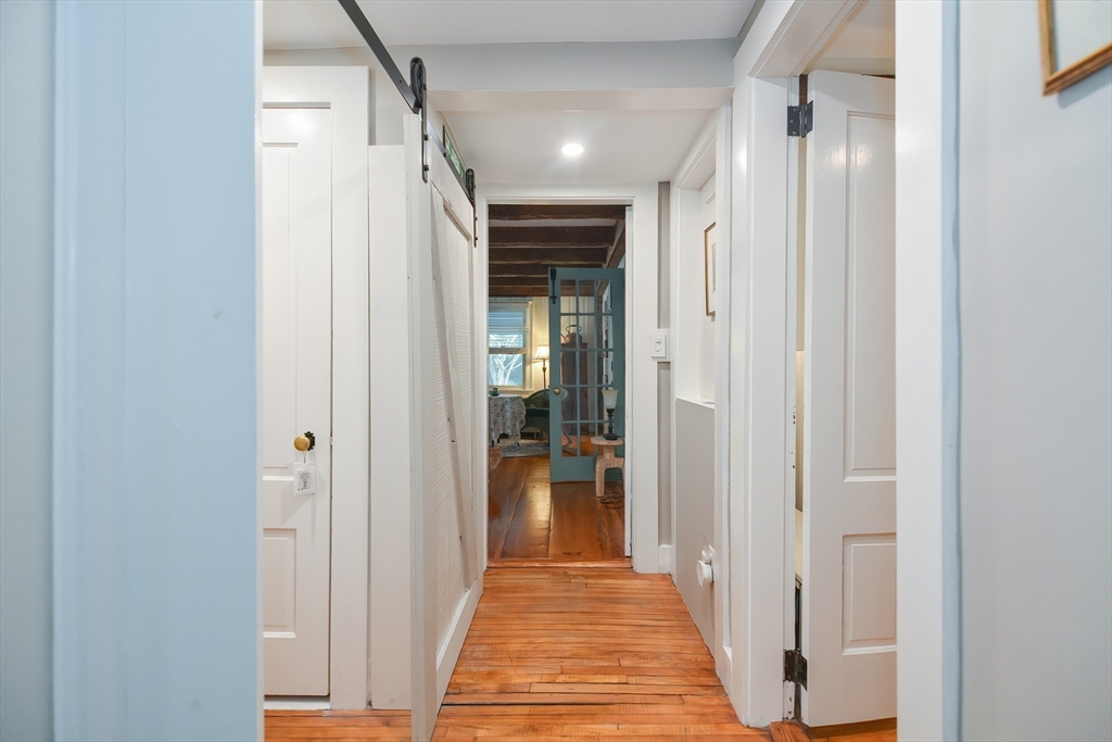 72 Appledor Road, Unit A Framingham, MA 01701 - Photo 31 of 39 a view of a hallway with wooden floor and a bathroom