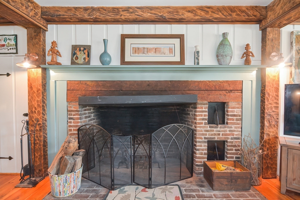 72 Appledor Road, Unit A Framingham, MA 01701 - Photo 9 of 39 a front view of a fireplace with window and potted plants