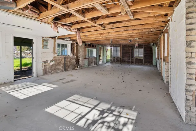 a view of a porch with a table and chairs