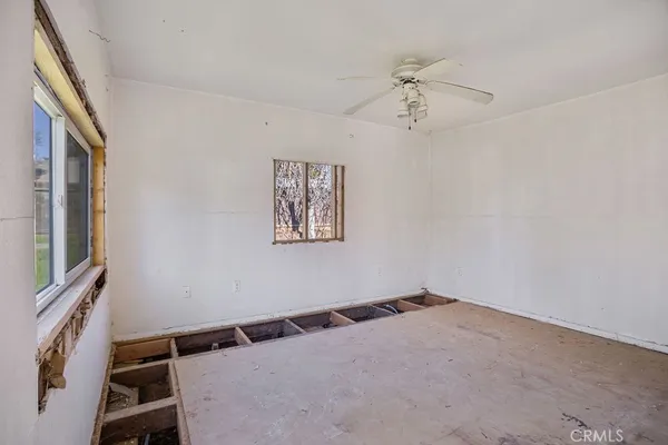 a view of a hallway with a window and a ceiling fan
