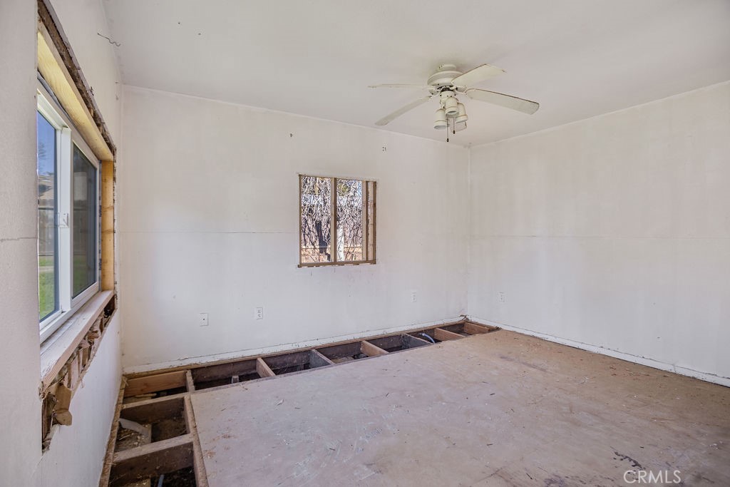 2520 McKee Road Merced, CA 95340 - Photo 7 of 13 a view of a hallway with a window and a ceiling fan