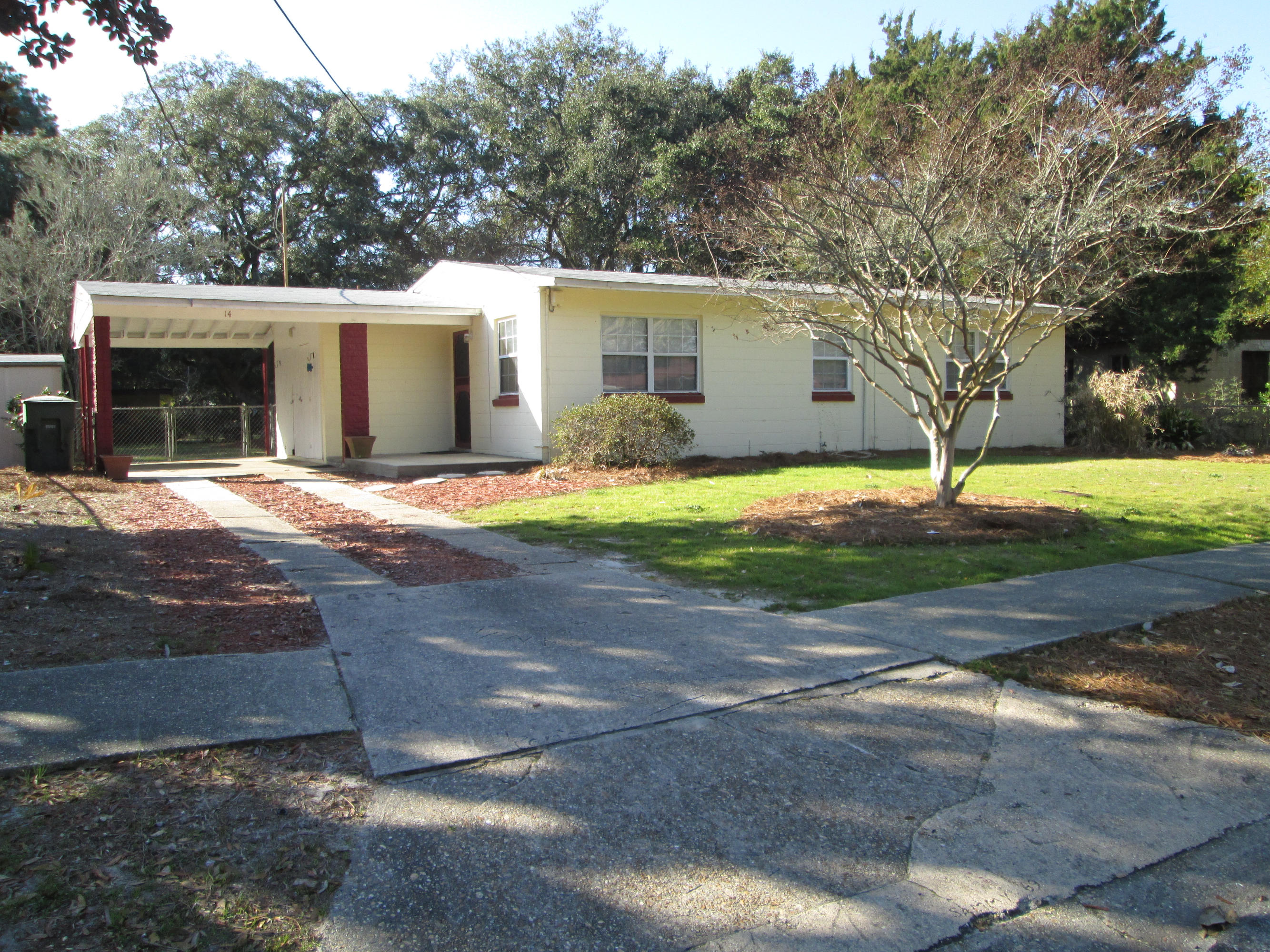 14 Ranger Street Southwest Fort Walton Beach, FL 32548 - Photo 1 of 10 a front view of a house with a yard and garage