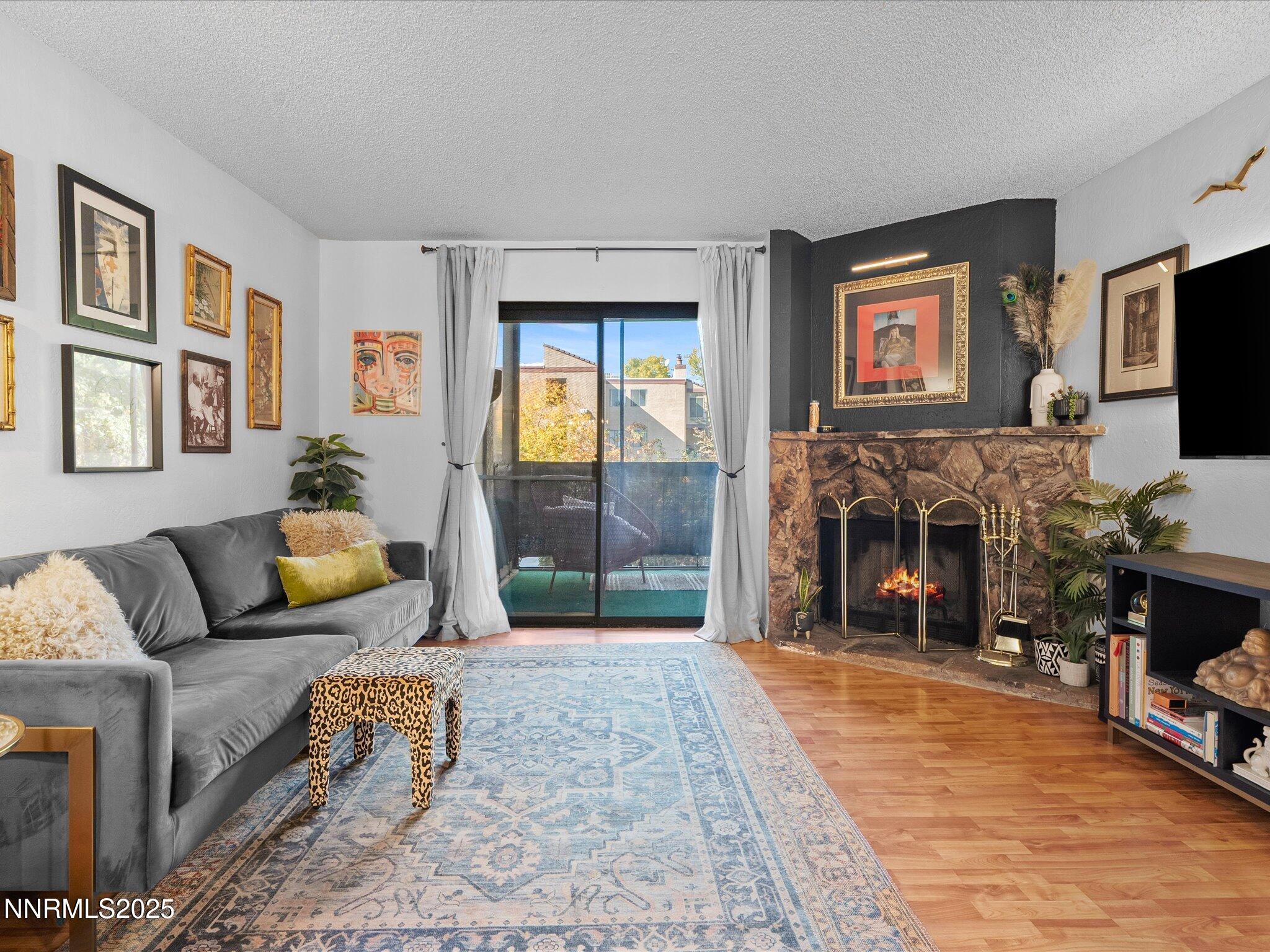 2955 Lakeside Drive, Unit 228 Reno, NV 89509 - Photo 4 of 41 a living room with furniture and a flat screen tv