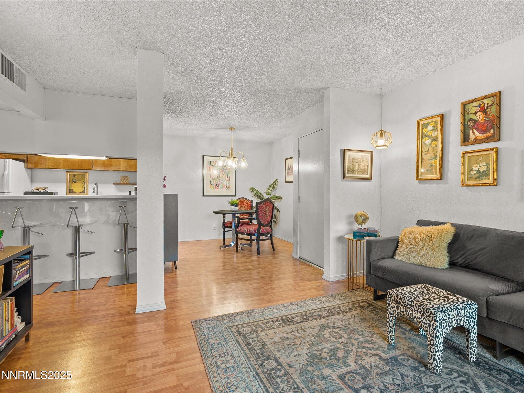 2955 Lakeside Drive, Unit 228 Reno, NV 89509 - Photo 6 of 41 a living room with furniture and a wooden floor