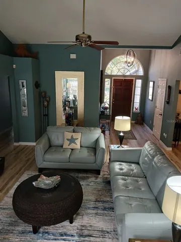 a living room with furniture and a chandelier