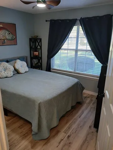 a bed sitting in a bedroom next to a window