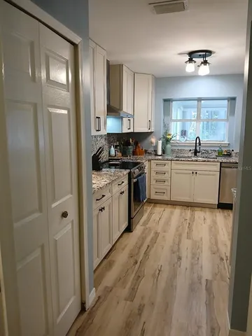 a kitchen with a sink stove and refrigerator