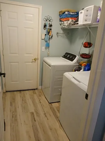 a view of a dining room with furniture wooden floor and chandelier