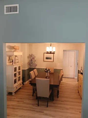 a kitchen with stainless steel appliances granite countertop a sink cabinets and wooden floor