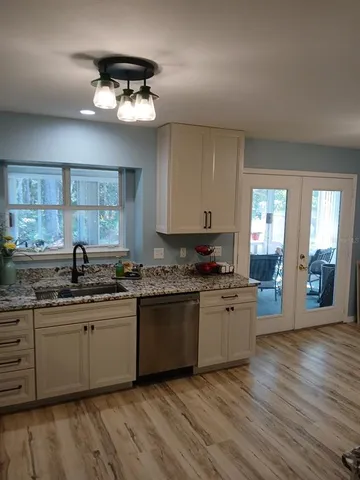 a kitchen with stainless steel appliances granite countertop a stove a sink and a refrigerator