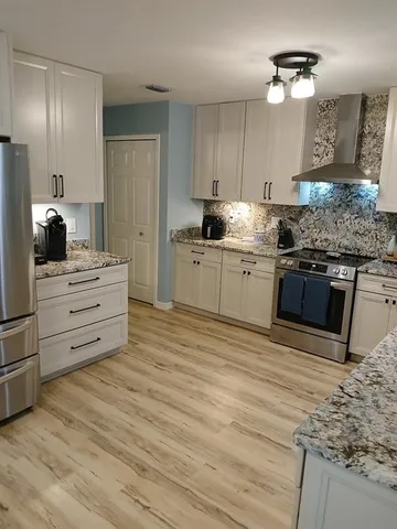 a kitchen with stainless steel appliances a refrigerator stove and microwave