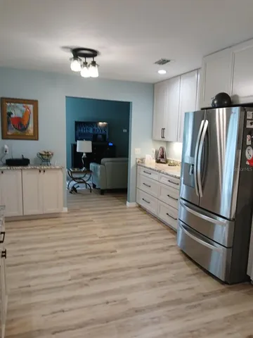 a kitchen with stainless steel appliances granite countertop a refrigerator sink and stove