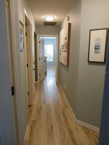 a view of a hallway with wooden floor